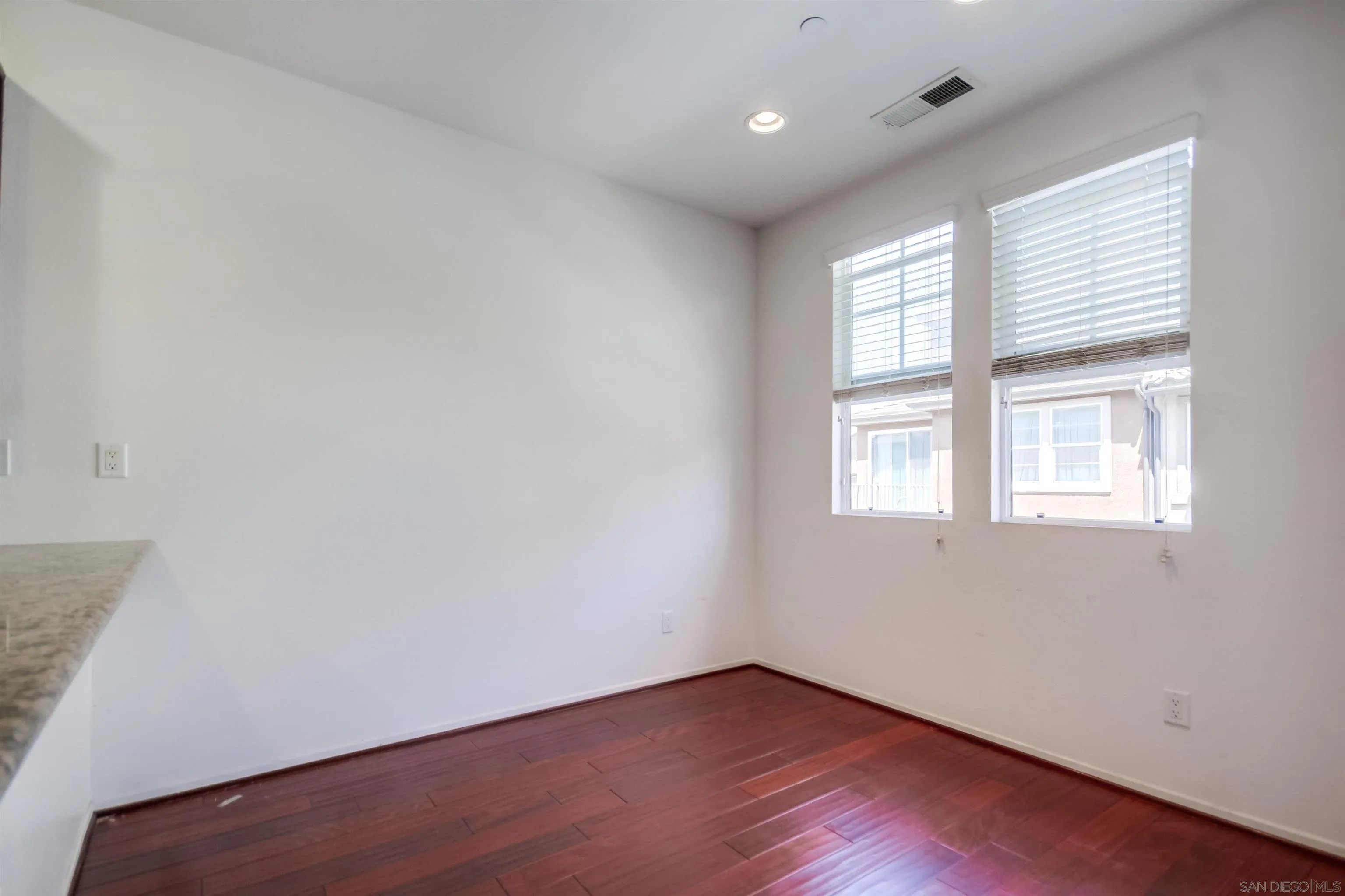 9810 Old Tree Lane Santee, CA 92071 - Photo 16 of 37 an empty room with wooden floor and windows
