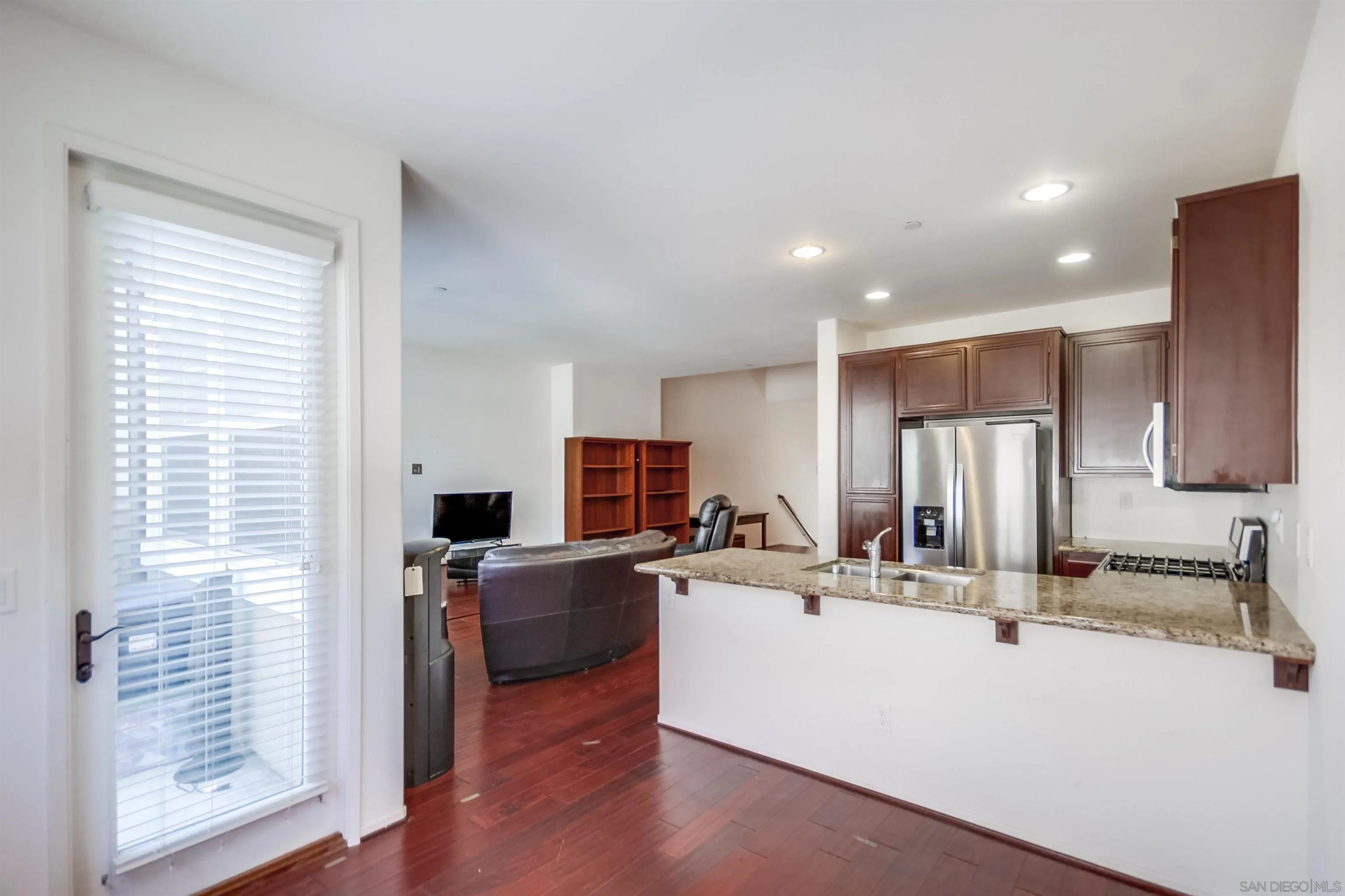 9810 Old Tree Lane Santee, CA 92071 - Photo 17 of 37 a view of kitchen with kitchen island stainless steel appliances a sink and a counter top space
