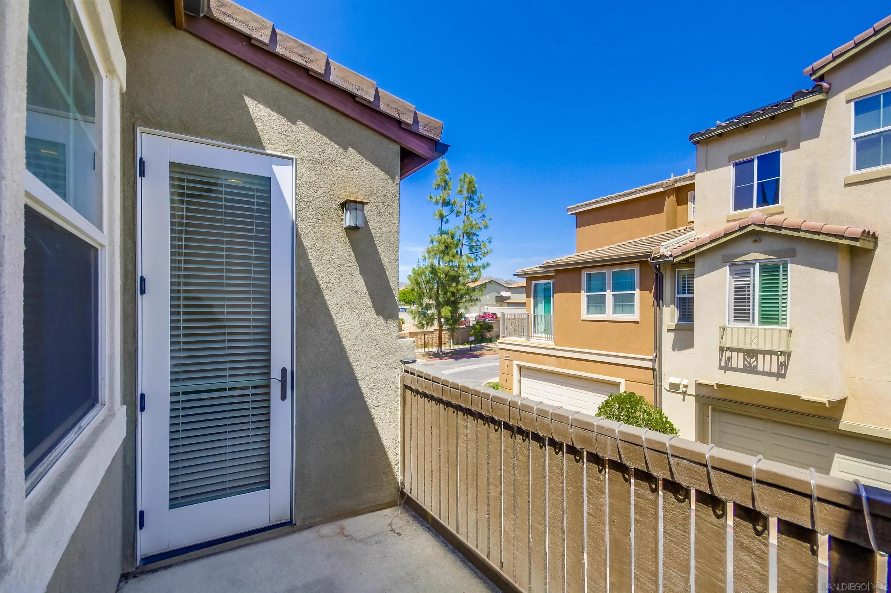 9810 Old Tree Lane Santee, CA 92071 - Photo 21 of 37 a view of a house with a balcony and wooden floor