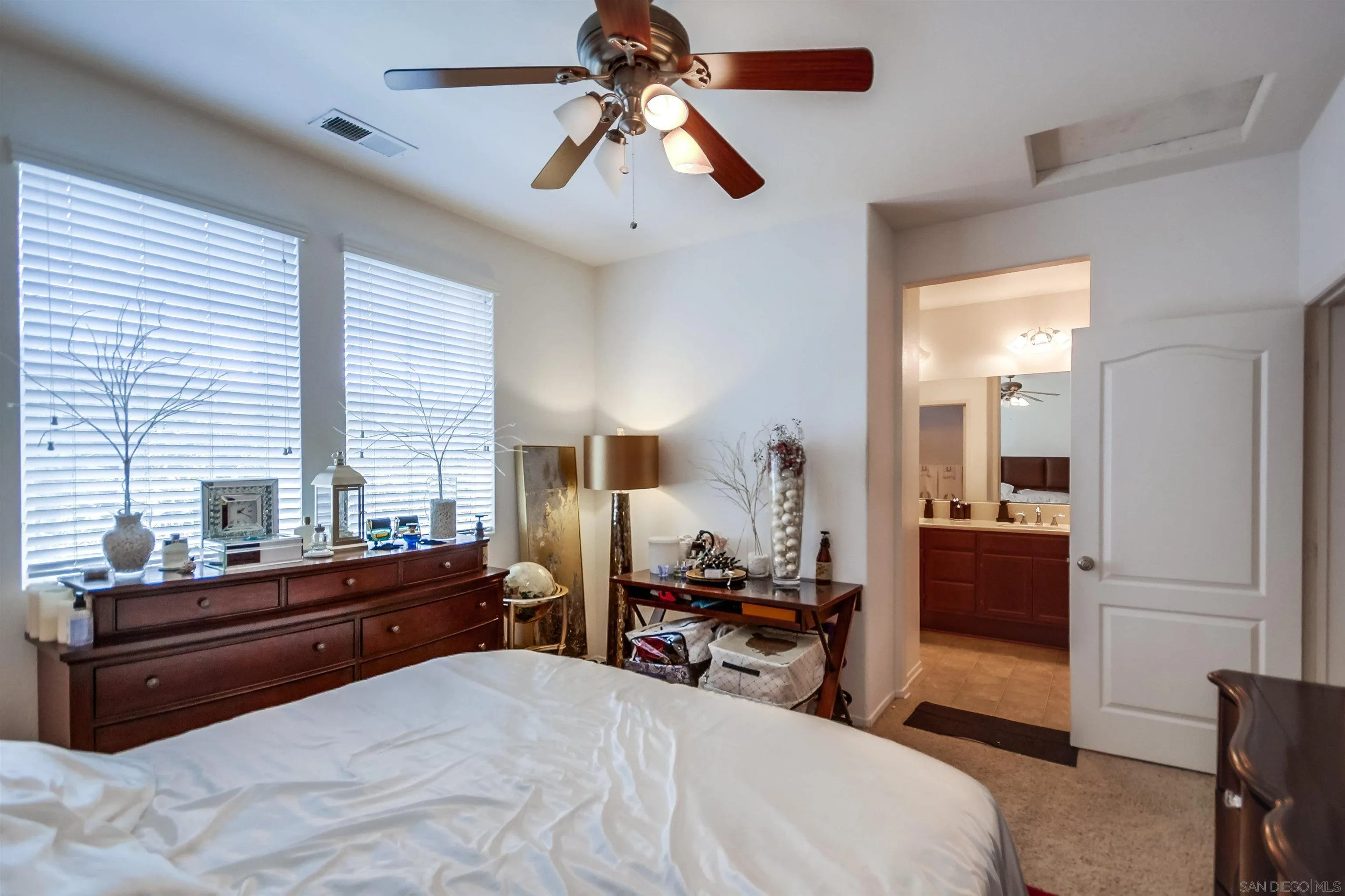 9810 Old Tree Lane Santee, CA 92071 - Photo 23 of 37 a bedroom with a bed and a chandelier