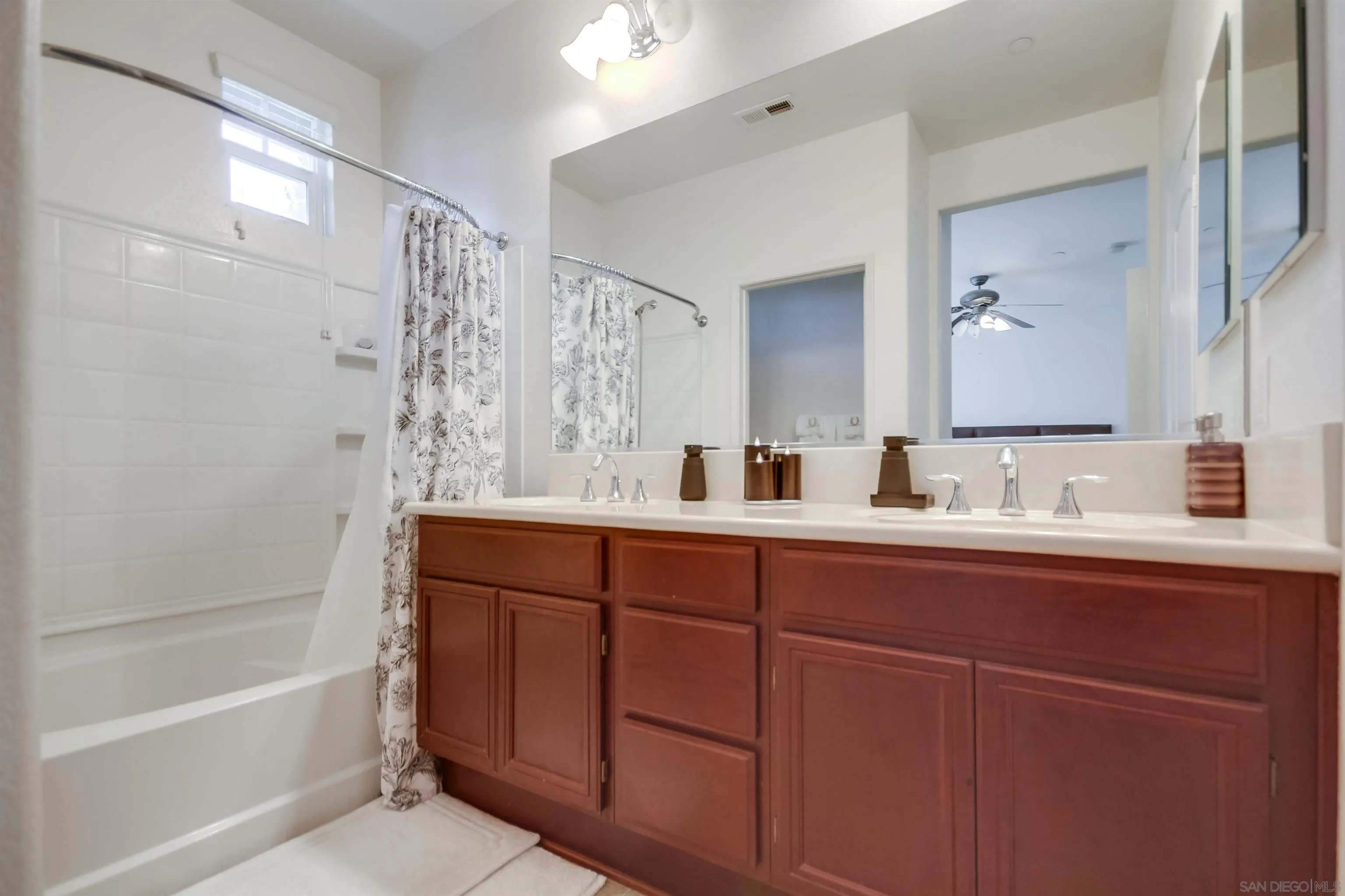 9810 Old Tree Lane Santee, CA 92071 - Photo 24 of 37 a bathroom with a tub sink and mirror