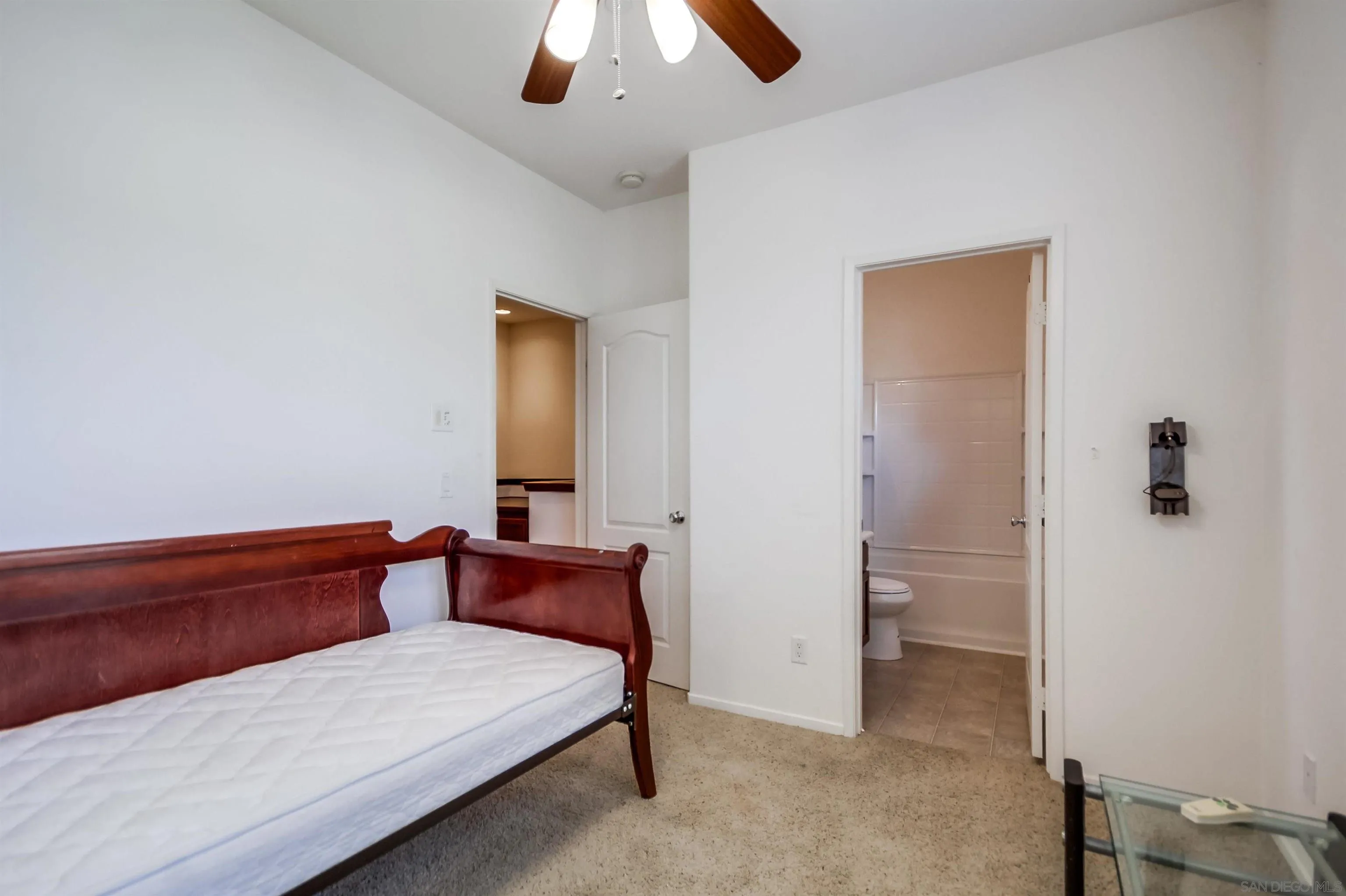 9810 Old Tree Lane Santee, CA 92071 - Photo 30 of 37 a bedroom with a bed and a chandelier