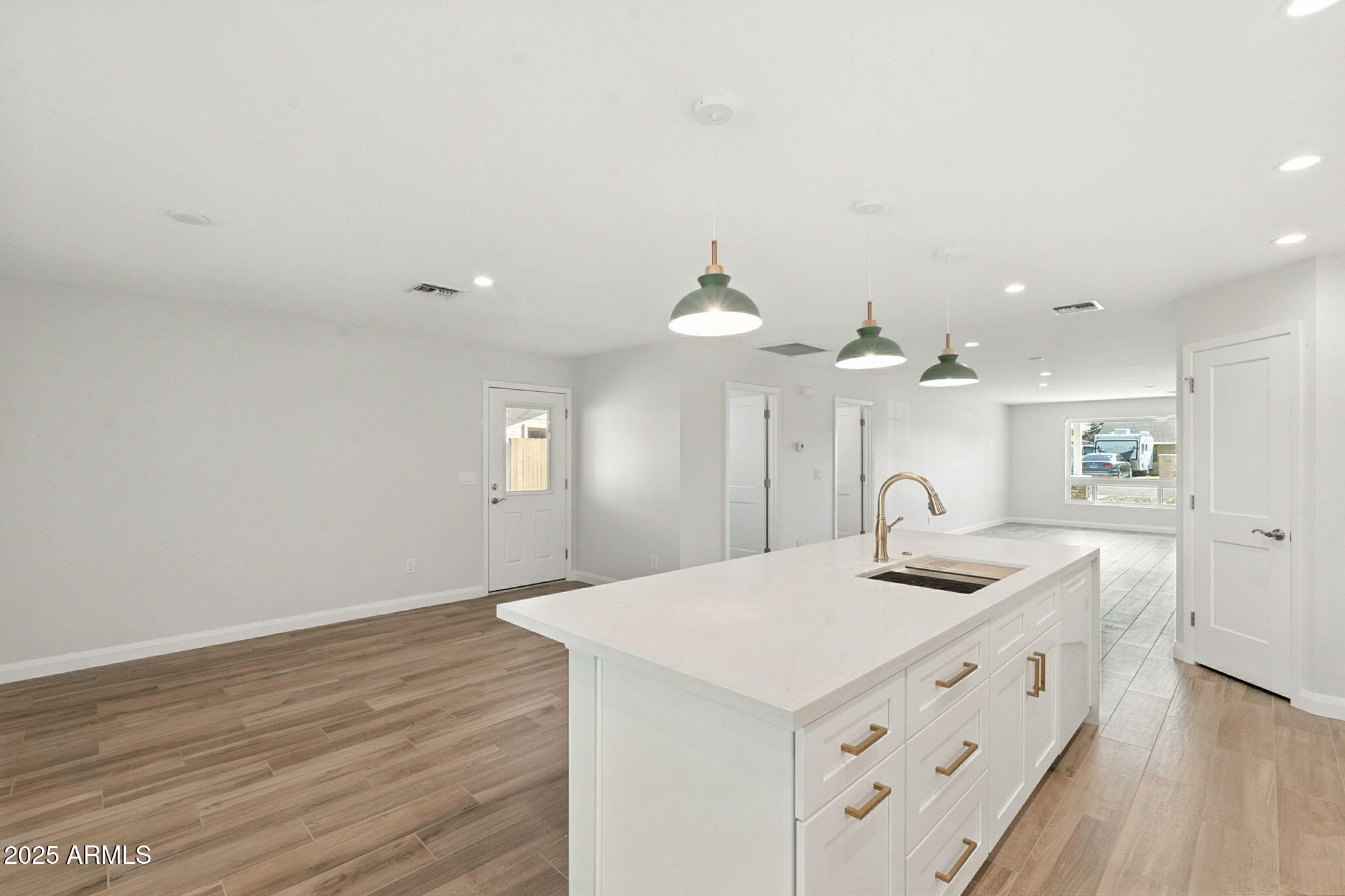 2814 North 51st Street Phoenix, AZ 85008 - Photo 13 of 50 a kitchen with a sink cabinets and wooden floor
