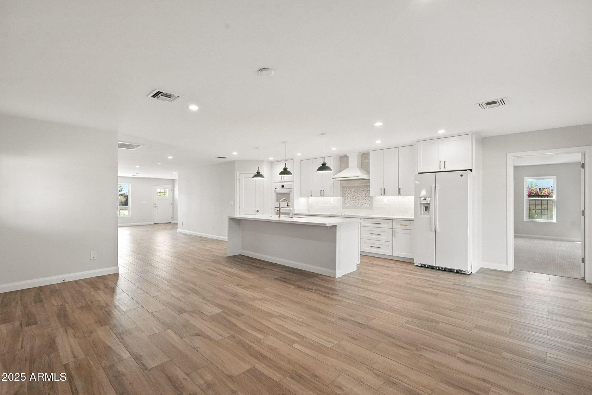 2814 North 51st Street Phoenix, AZ 85008 - Photo 17 of 50 a kitchen with stainless steel appliances cabinets and wooden floor