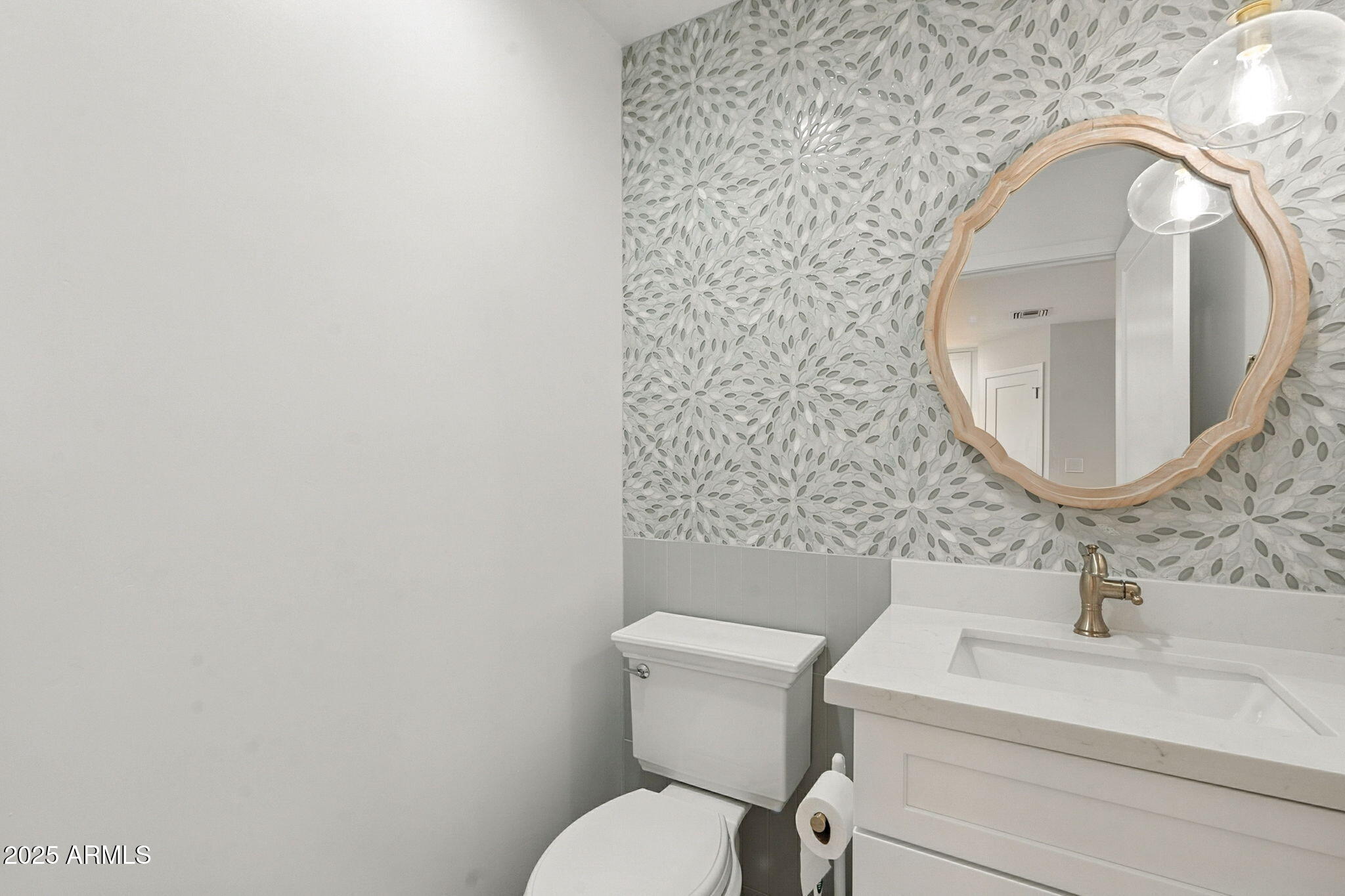 2814 North 51st Street Phoenix, AZ 85008 - Photo 18 of 50 a bathroom with a toilet sink and mirror