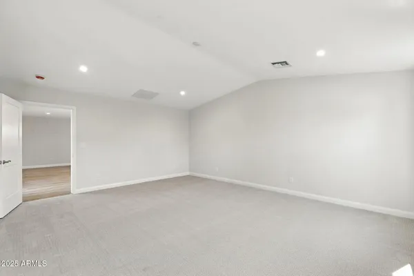 a spacious bathroom with a double vanity sink a mirror and a window