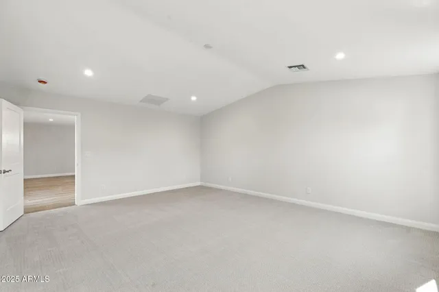 a spacious bathroom with a double vanity sink a mirror and a window