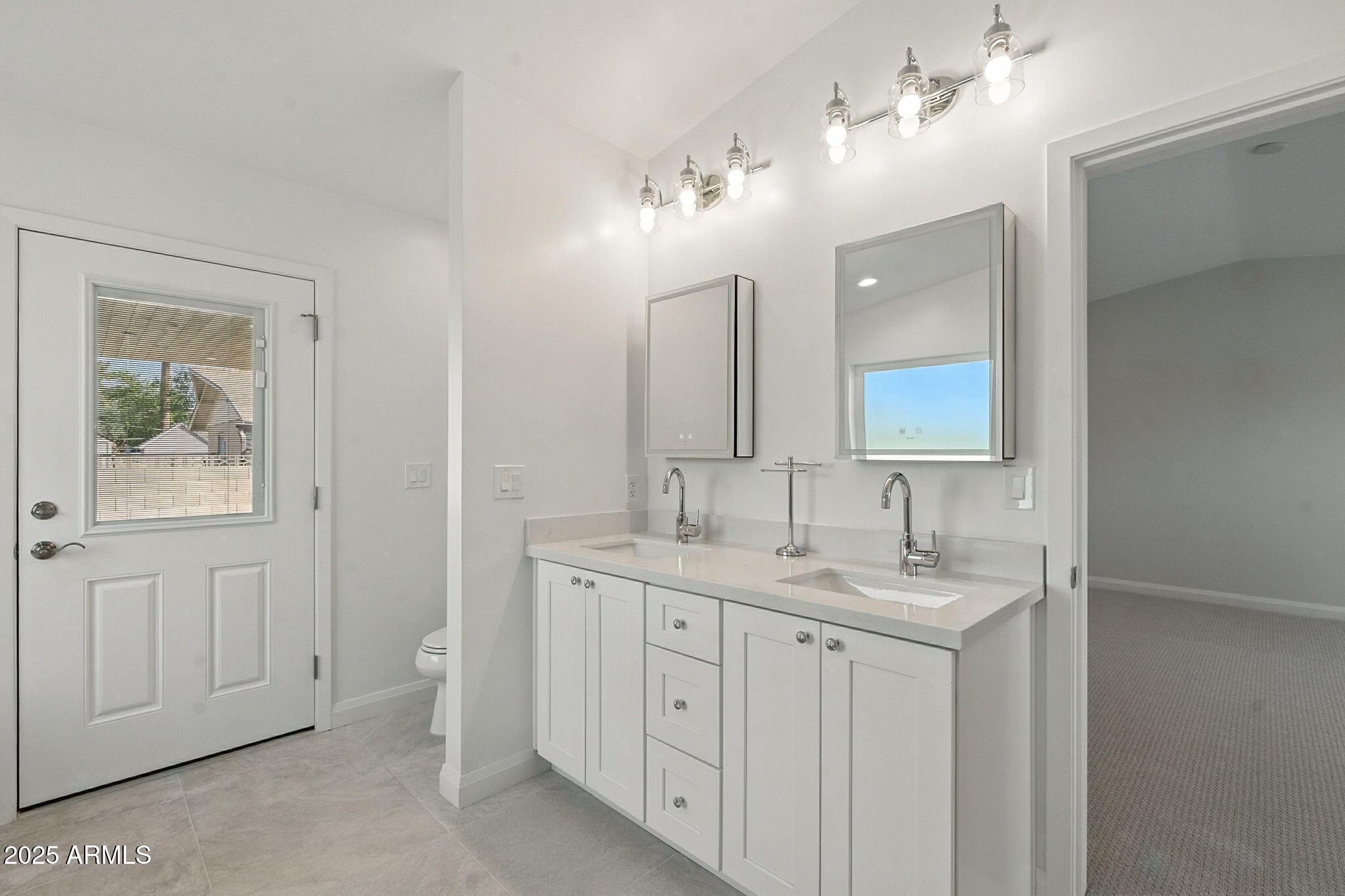2814 North 51st Street Phoenix, AZ 85008 - Photo 35 of 50 a spacious bathroom with a double vanity sink a mirror and a window