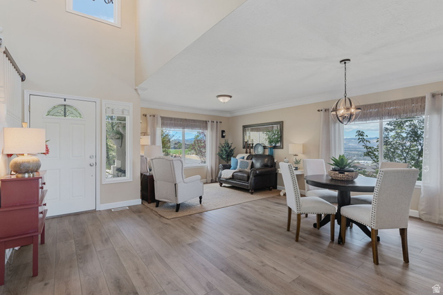 14883 Tooele Lane Draper, UT 84020 - Photo 13 of 49 Bright entryway with wood-finish flooring, featuring a decorative glass panel door and a tall window