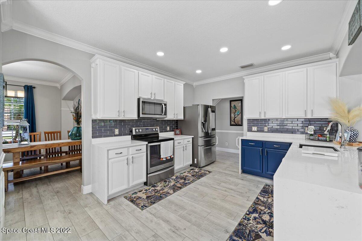 4225 Fenrose Circle Melbourne, FL 32940 - Photo 13 of 49 a kitchen with furniture a counter top space stainless steel appliances and cabinets