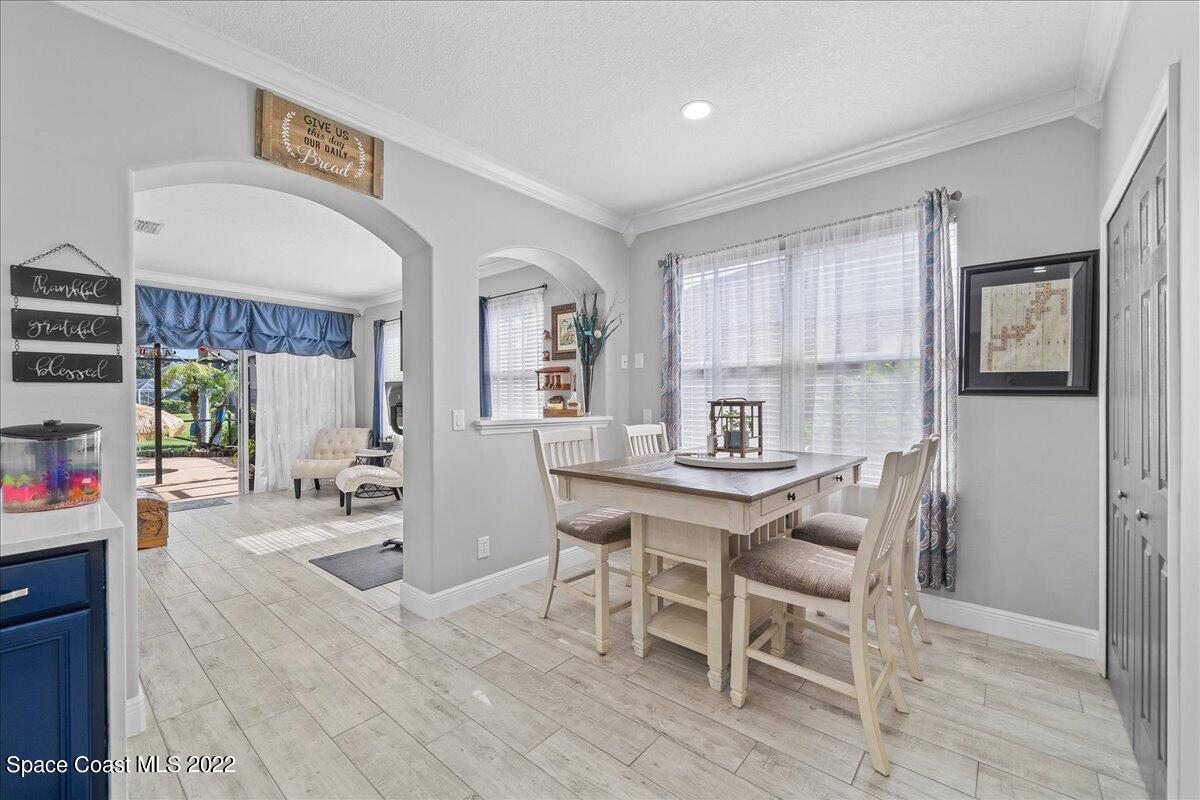 4225 Fenrose Circle Melbourne, FL 32940 - Photo 15 of 49 a view of a dining room with furniture and wooden floor