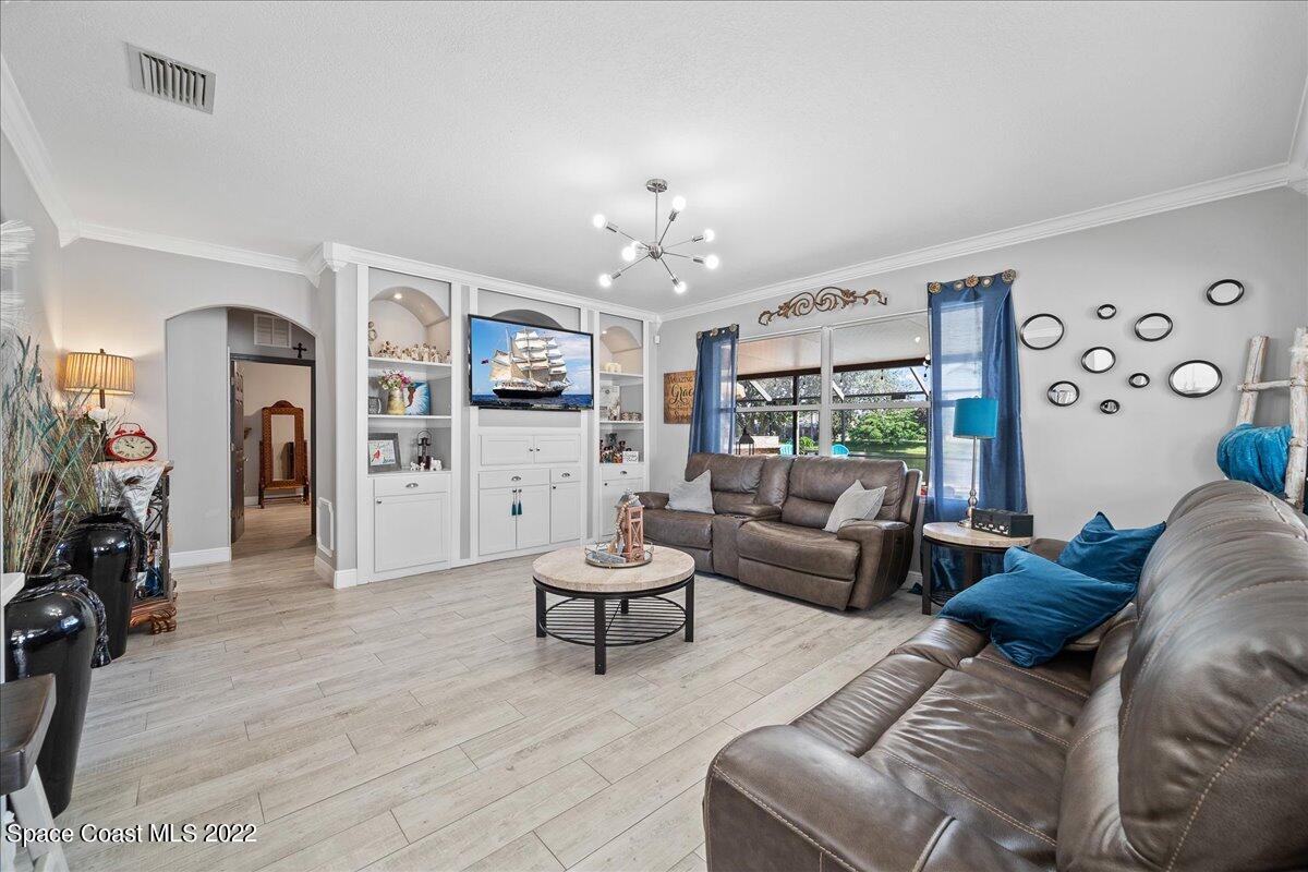 4225 Fenrose Circle Melbourne, FL 32940 - Photo 16 of 49 a living room with furniture and a chandelier