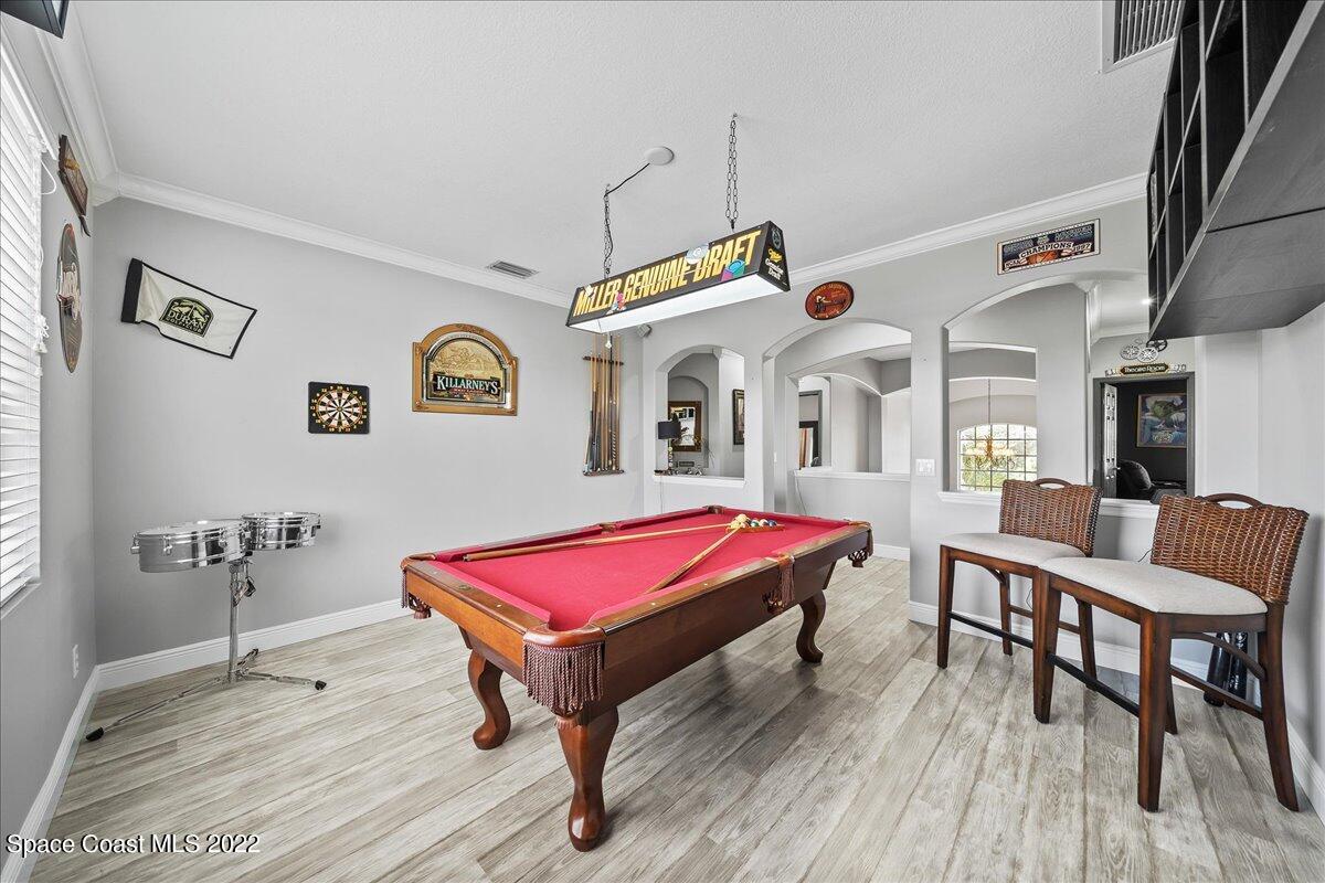 4225 Fenrose Circle Melbourne, FL 32940 - Photo 21 of 49 a living room with furniture a table and wooden floor