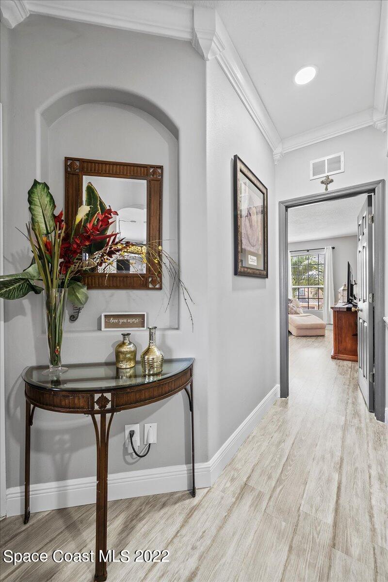 4225 Fenrose Circle Melbourne, FL 32940 - Photo 25 of 49 a view of a hallway with furniture and wooden floor