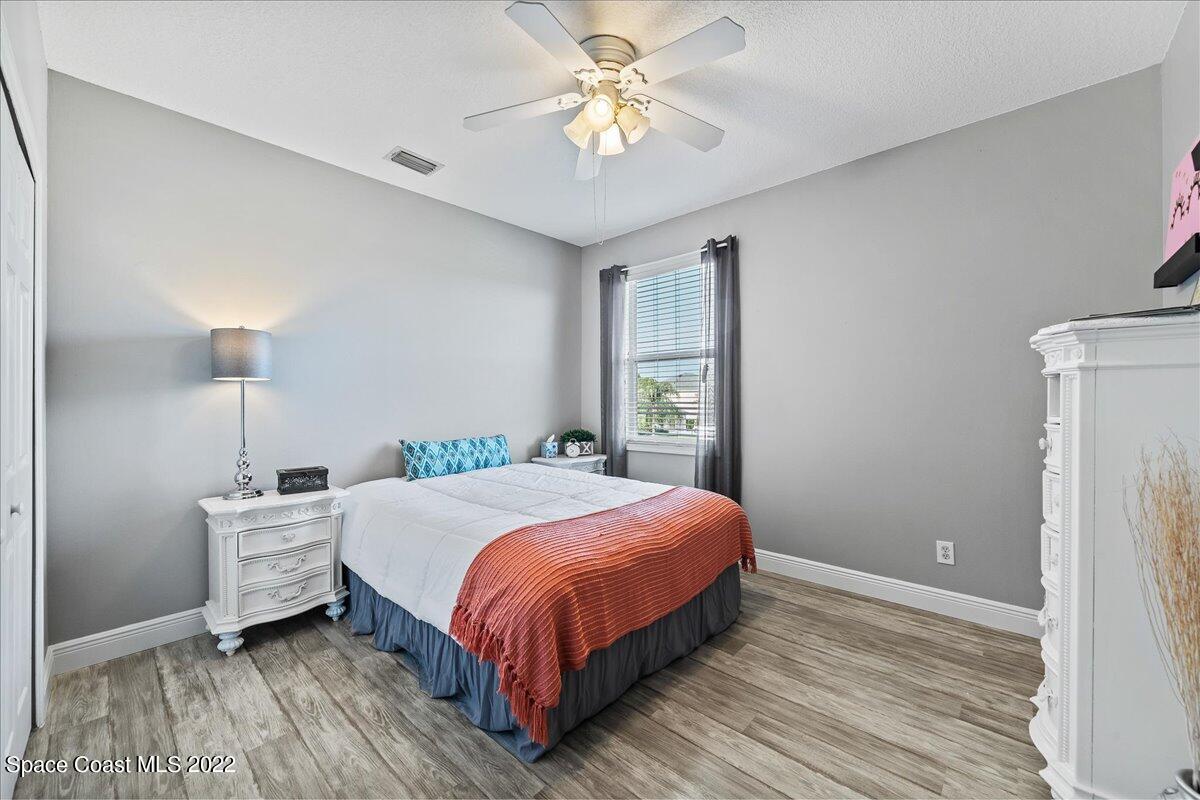 4225 Fenrose Circle Melbourne, FL 32940 - Photo 30 of 49 a bedroom with a bed and a chandelier