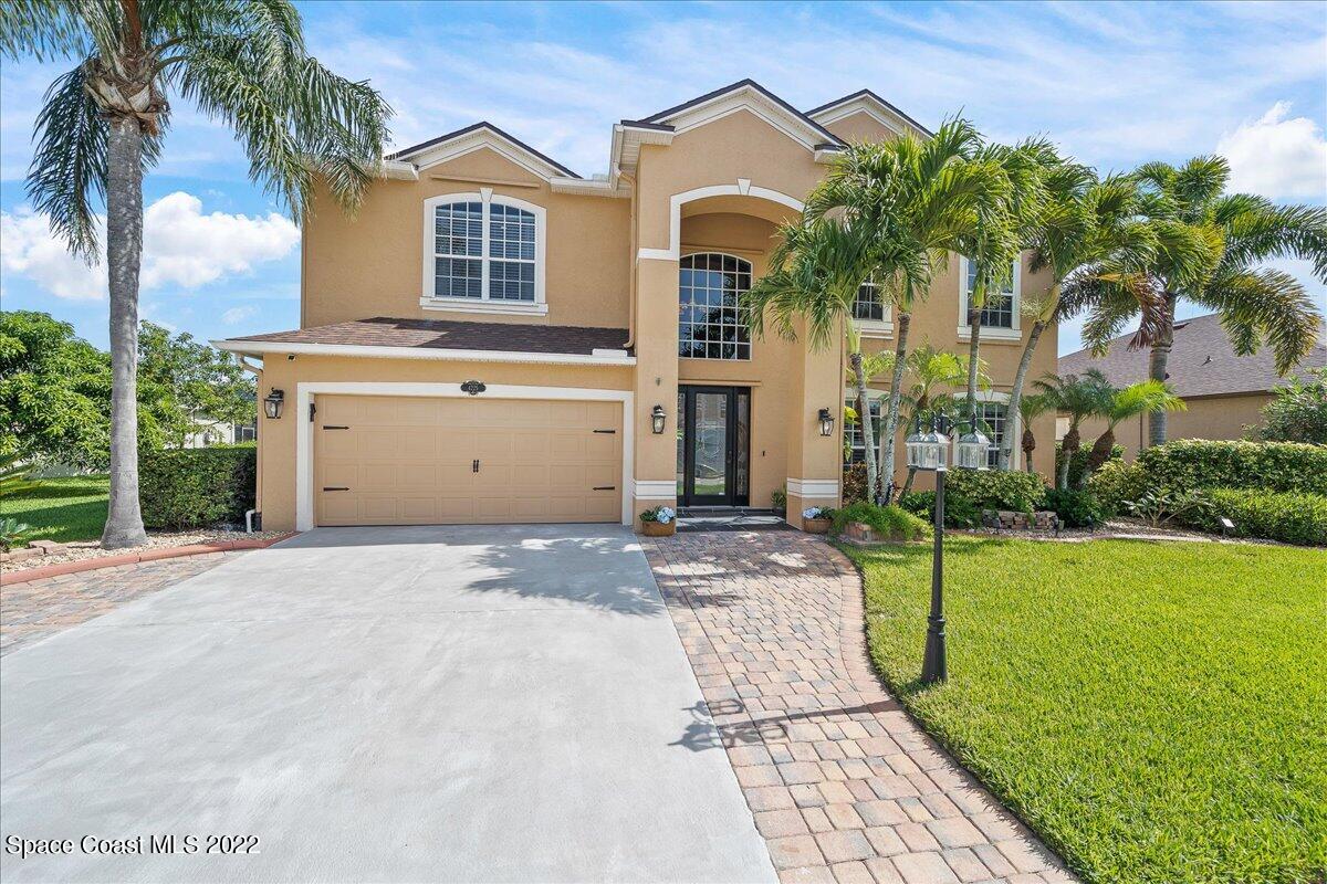 4225 Fenrose Circle Melbourne, FL 32940 - Photo 3 of 49 a front view of a house with a yard and garage