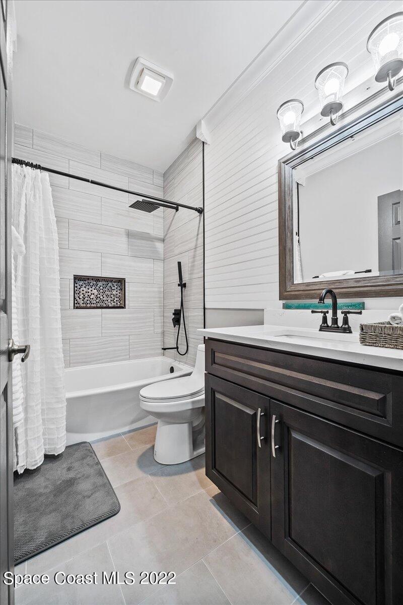 4225 Fenrose Circle Melbourne, FL 32940 - Photo 32 of 49 a spacious bathroom with a sink a toilet a mirror and bathtub