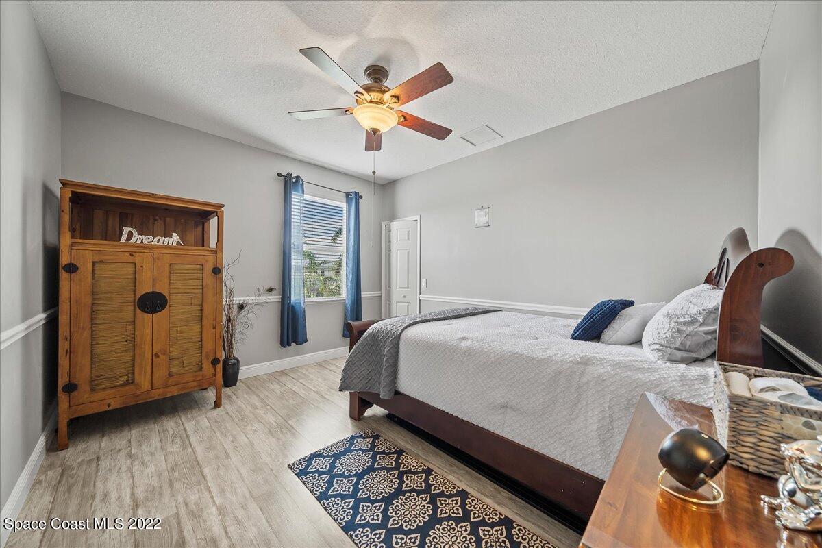 4225 Fenrose Circle Melbourne, FL 32940 - Photo 33 of 49 a bedroom with a bed and a chandelier