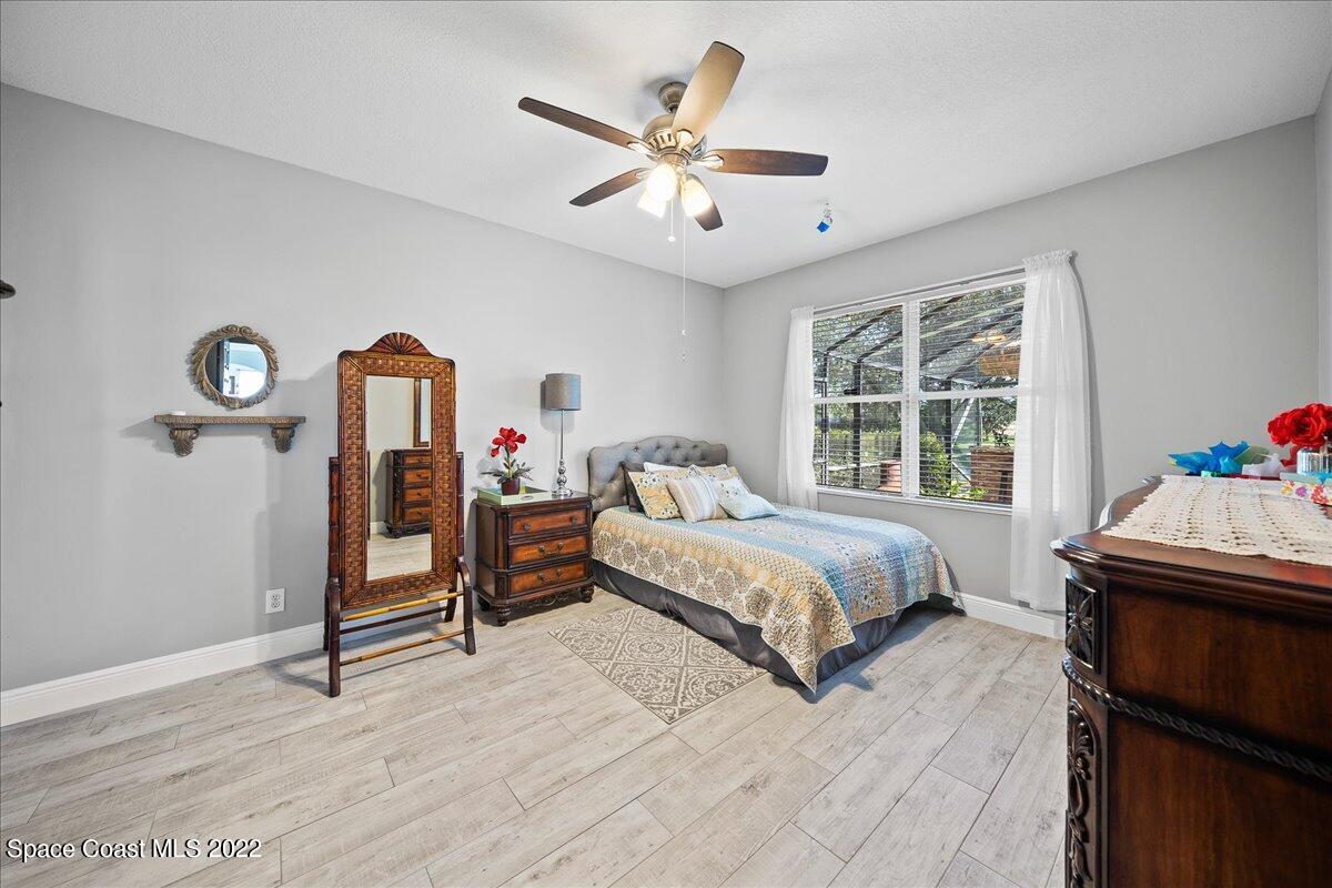 4225 Fenrose Circle Melbourne, FL 32940 - Photo 36 of 49 a bedroom with a bed table and a window