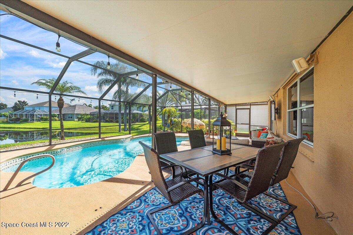 4225 Fenrose Circle Melbourne, FL 32940 - Photo 39 of 49 a view of a dining room with furniture a chandelier and wooden floor