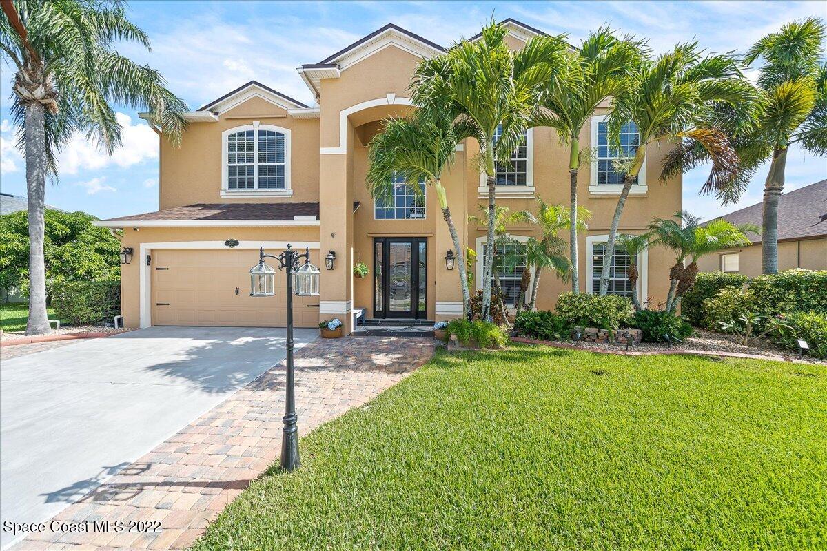 4225 Fenrose Circle Melbourne, FL 32940 - Photo 4 of 49 a front view of a house with a yard and garage