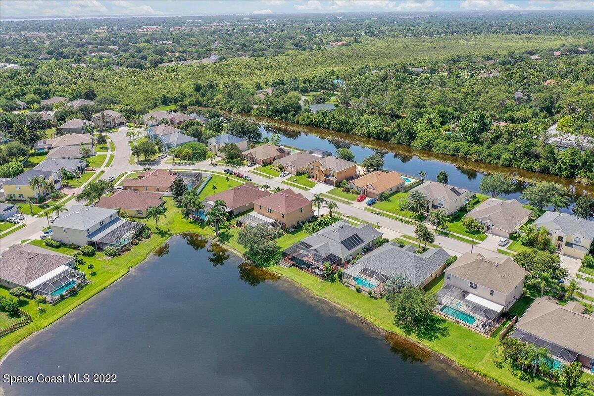 4225 Fenrose Circle Melbourne, FL 32940 - Photo 46 of 49 an aerial view of a city with lots of residential buildings ocean and mountain view in back
