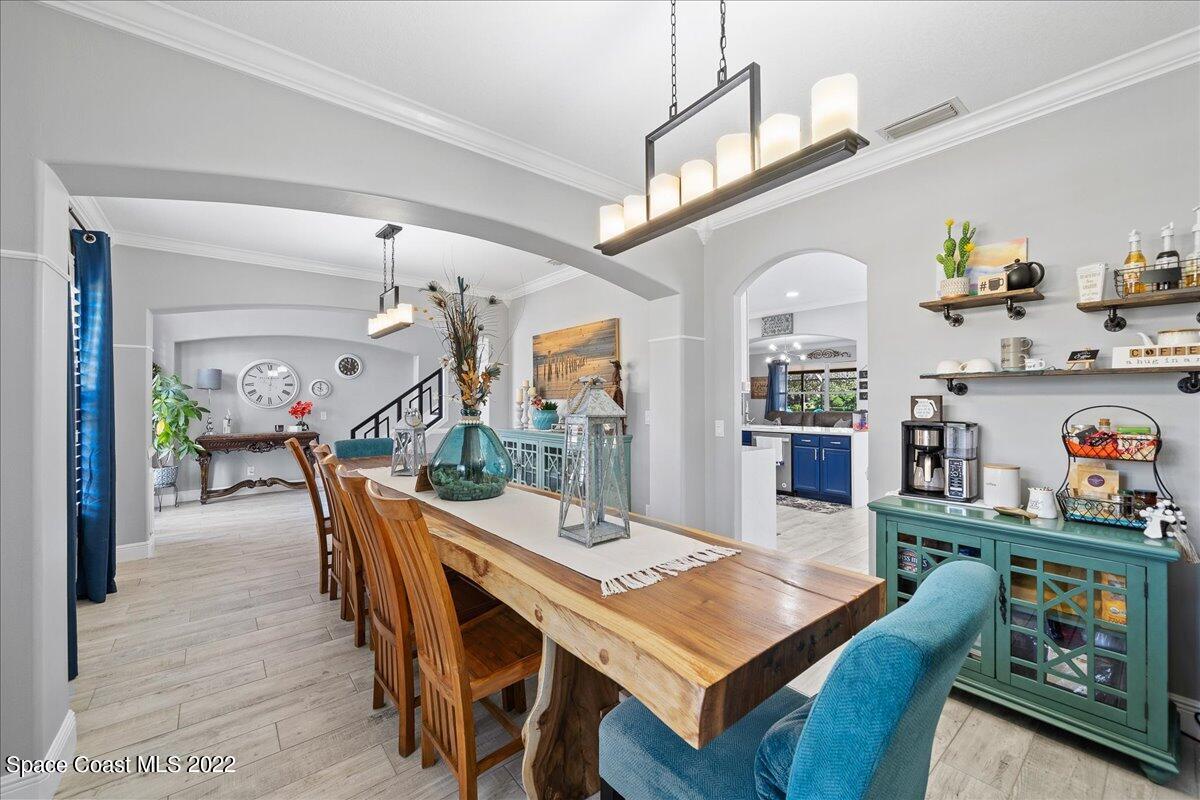 4225 Fenrose Circle Melbourne, FL 32940 - Photo 9 of 49 a view of a dining room with furniture and a chandelier