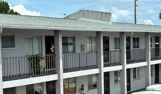 a view of a brick house with large windows