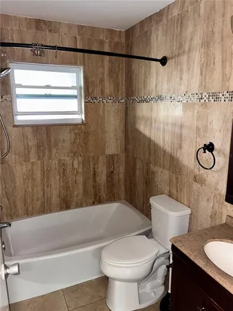 a bathroom with a toilet a sink and bathtub