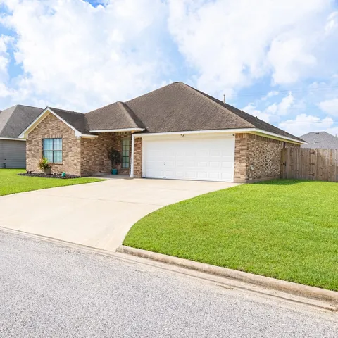 a front view of house with yard and green space