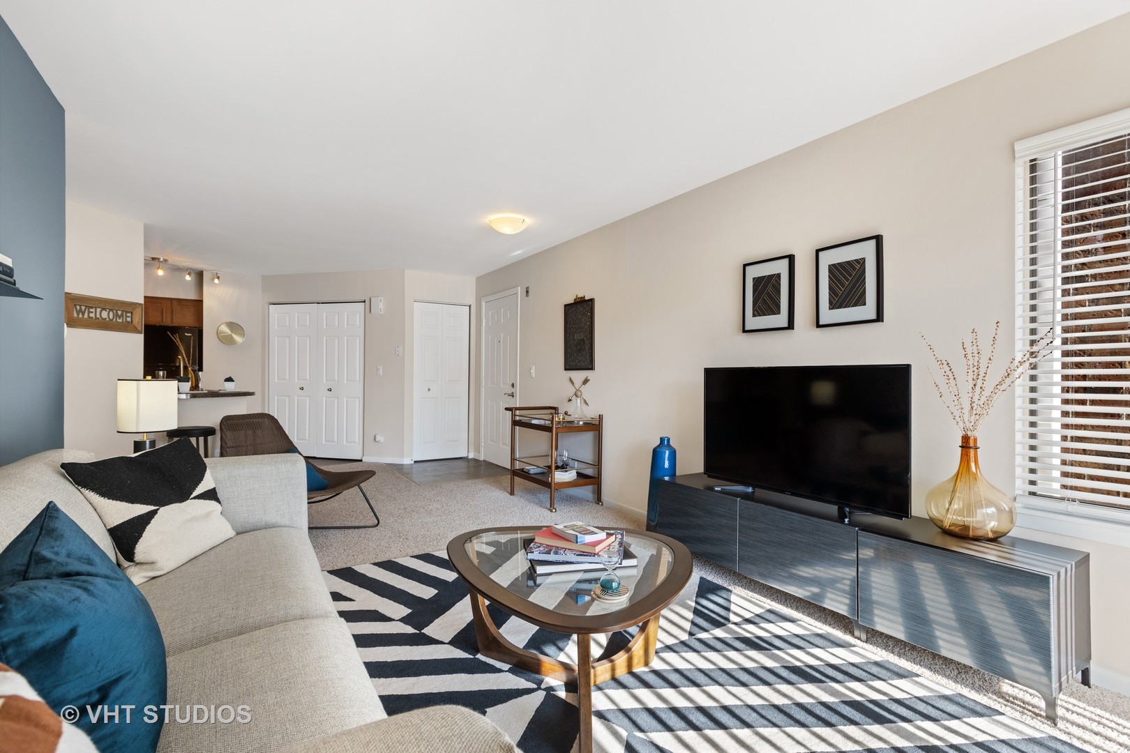 1919 Brookdale Road, Unit 209 Naperville, IL 60563 - Photo 18 of 53 a living room with furniture a flat screen tv and a fireplace
