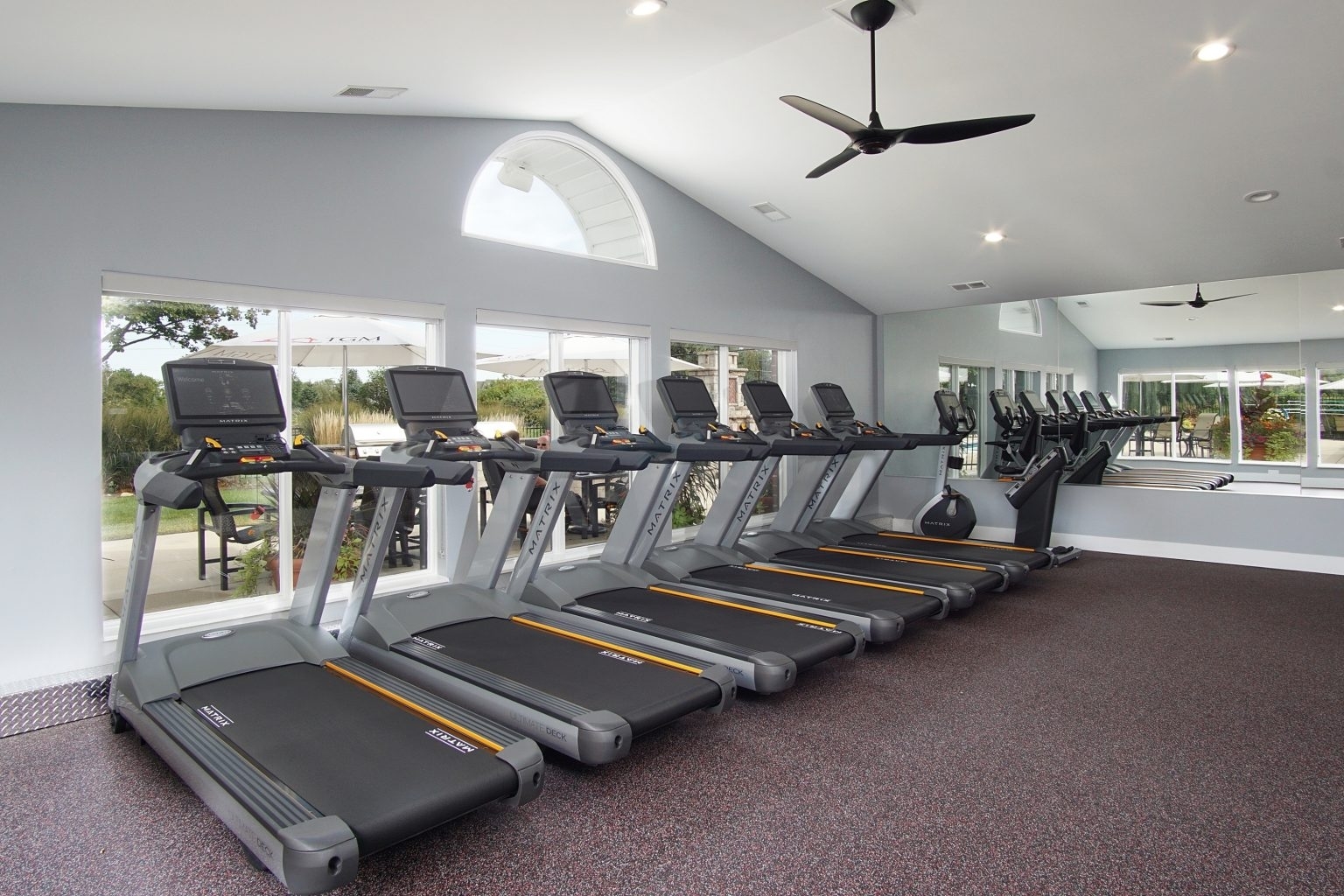 1919 Brookdale Road, Unit 209 Naperville, IL 60563 - Photo 3 of 53 a room with gym equipment and a chandelier