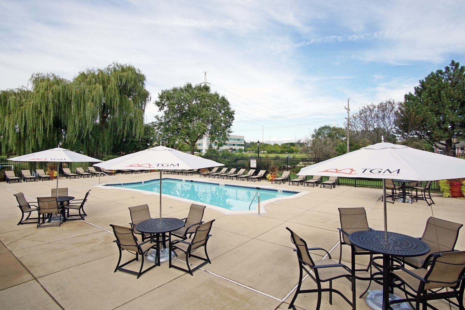 1919 Brookdale Road, Unit 209 Naperville, IL 60563 - Photo 10 of 53 a view of a patio with chairs and a table under an umbrella