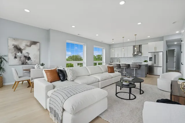 a living room with furniture and kitchen view