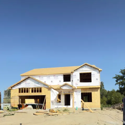 a view of white house with a yard