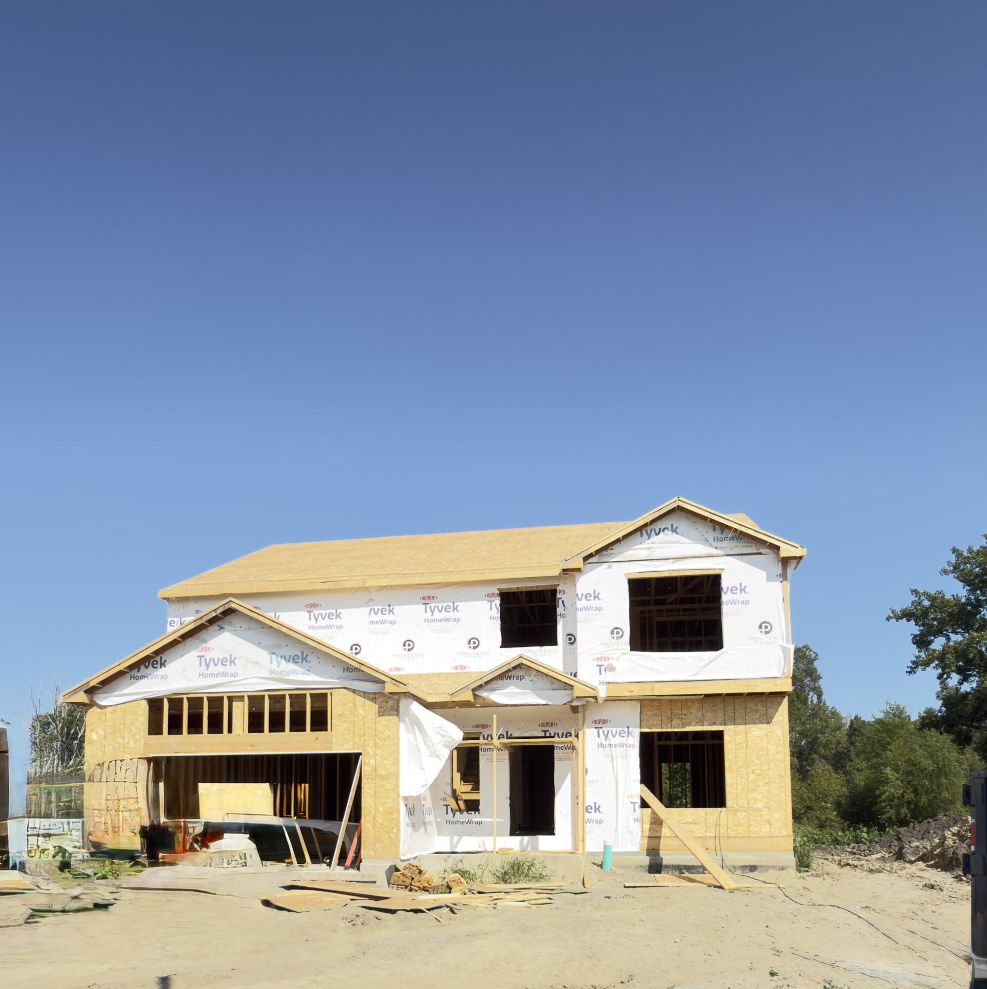 a view of white house with a yard