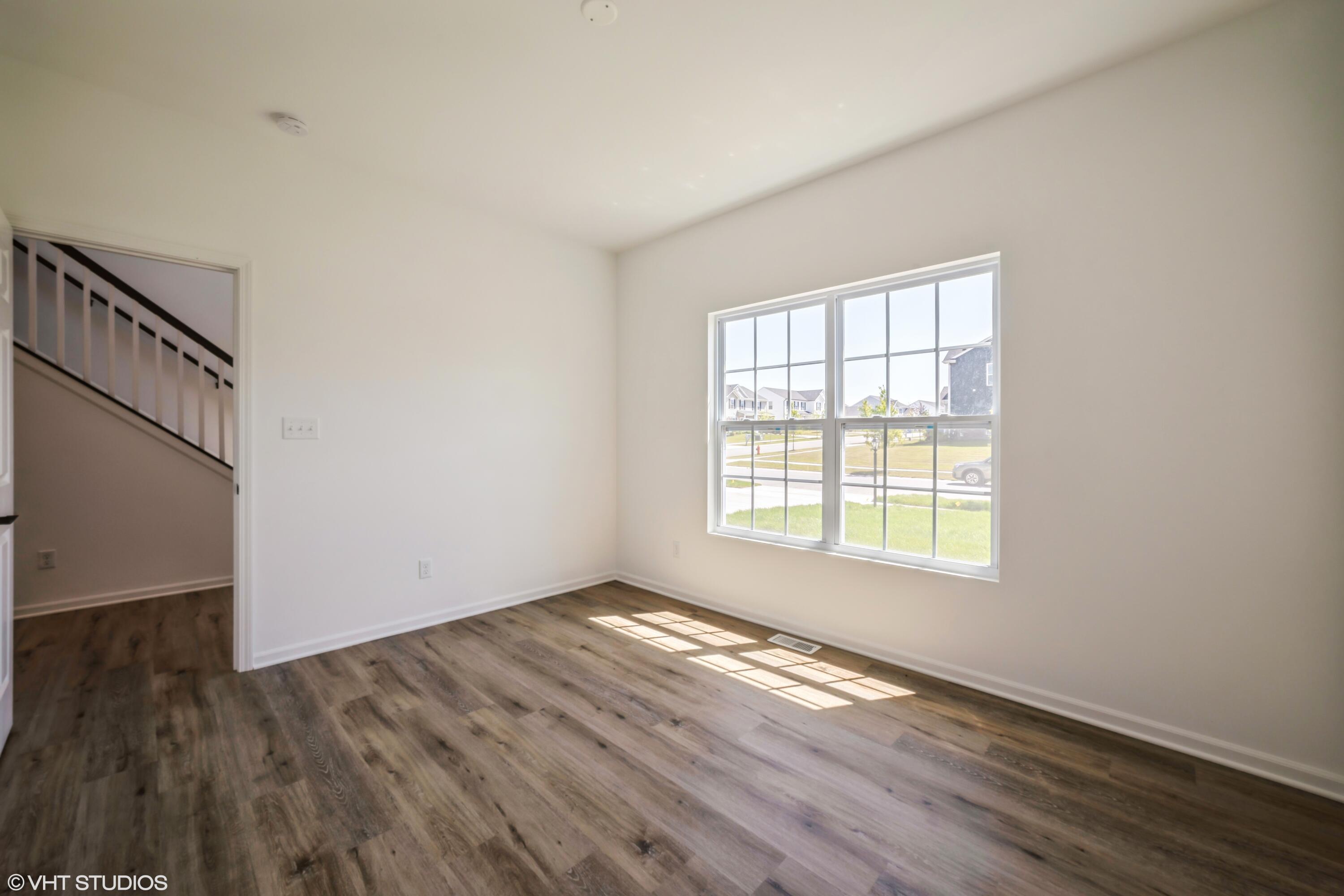 10344 Nevada Place Crown Point, IN 46307 - Photo 4 of 23 an empty room with wooden floor and windows