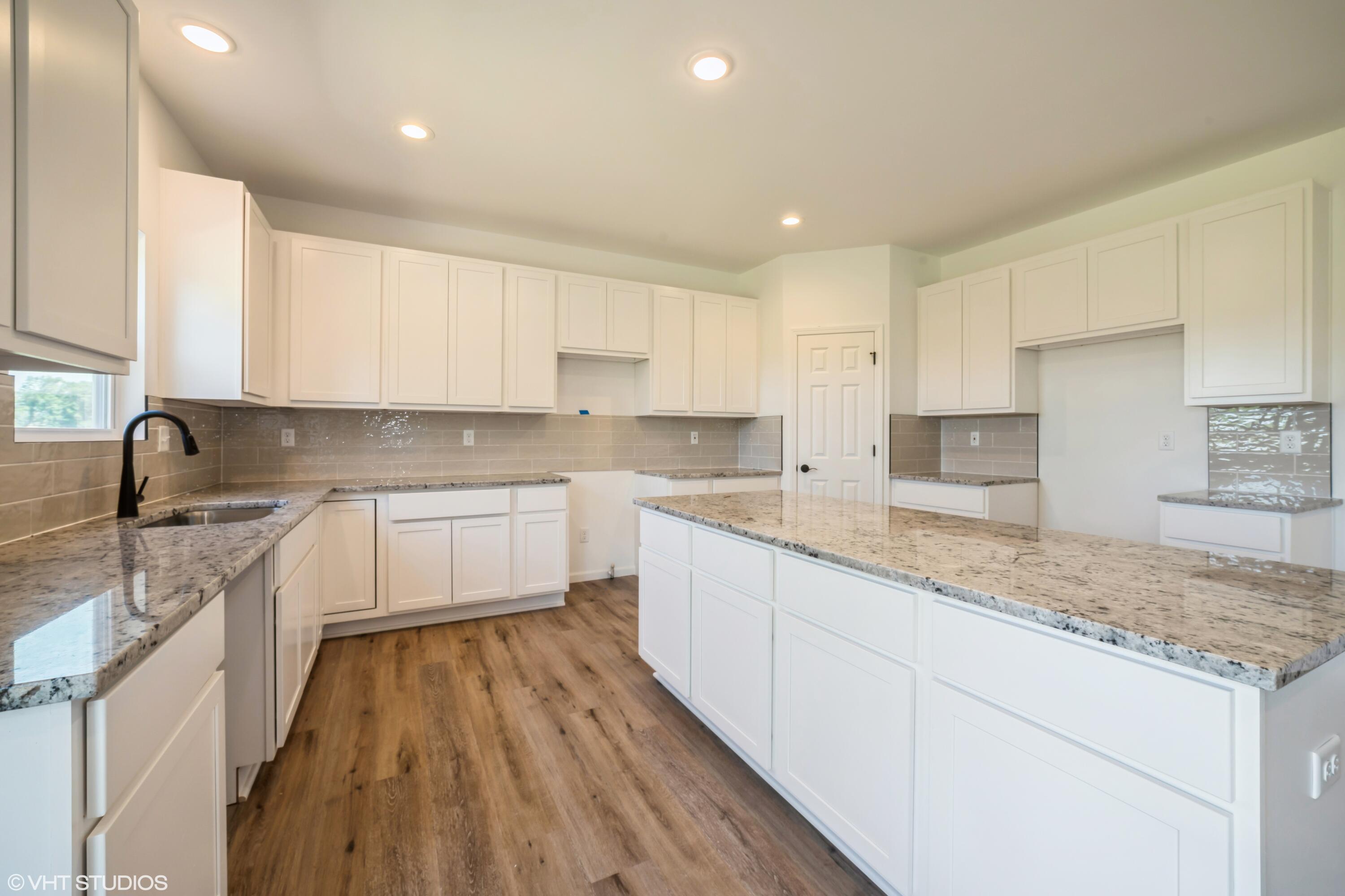 10344 Nevada Place Crown Point, IN 46307 - Photo 8 of 23 a kitchen with granite countertop white cabinets and white appliances
