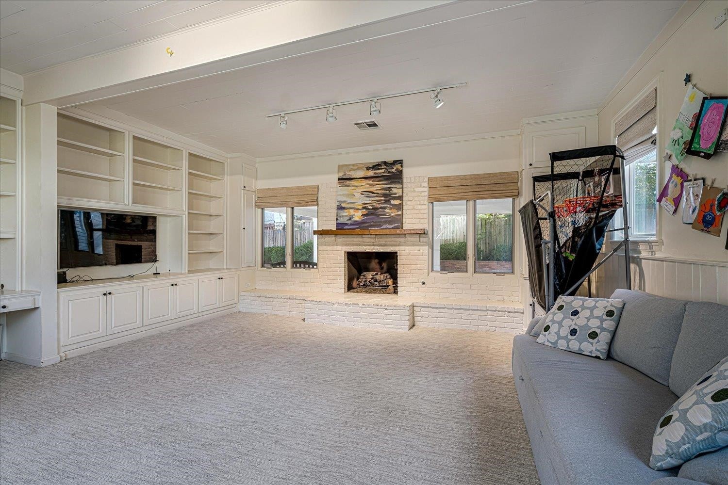 4160 Tuckahoe Road Memphis, TN 38117 - Photo 30 of 39 a living room with furniture a flat screen tv and a fireplace