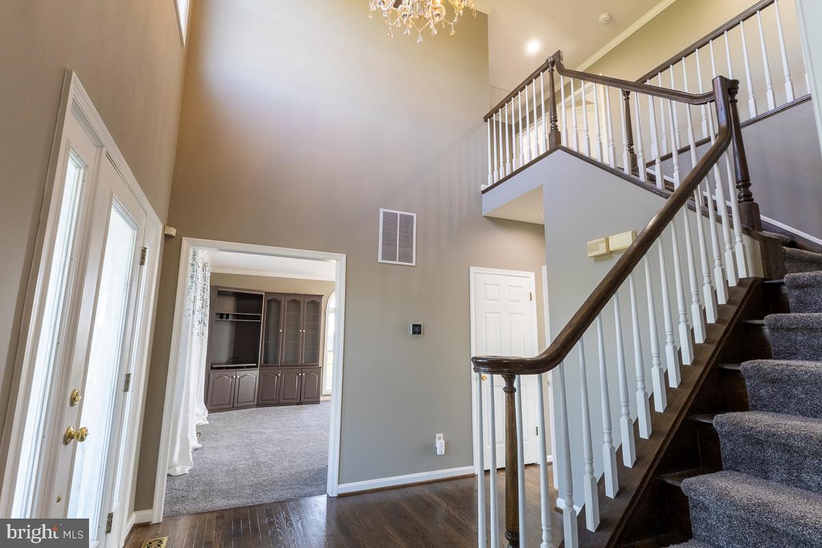 9630 Clemsonville Road Union Bridge, MD 21791 - Photo 11 of 70 a view of staircase with lots of frames on wall and wooden floor