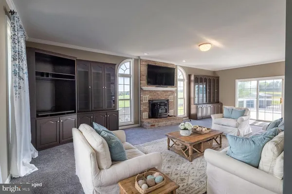 a living room with furniture fireplace and a flat screen tv