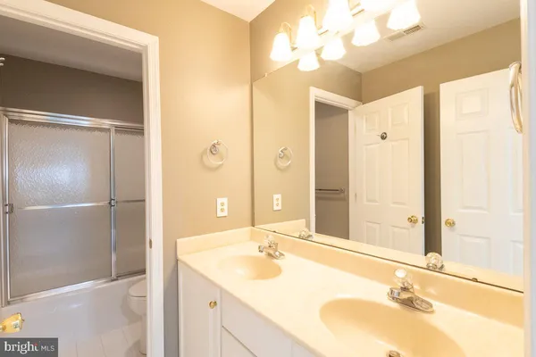 a bathroom with a tub sink and a mirror