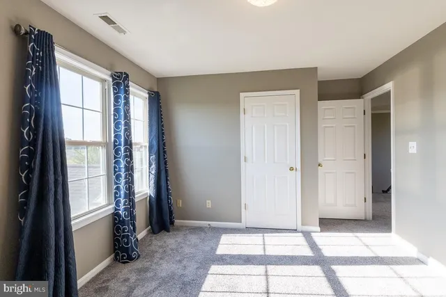 a view of hallway with wooden floor