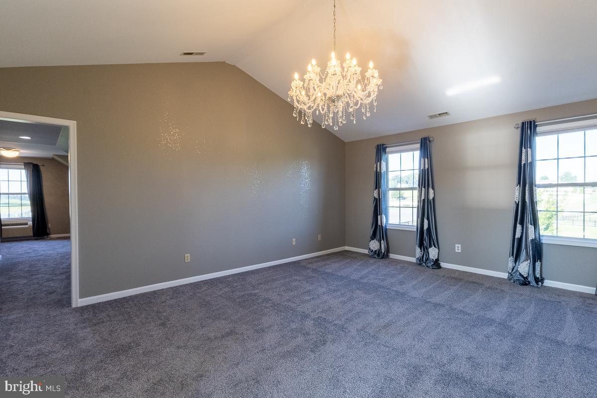 9630 Clemsonville Road Union Bridge, MD 21791 - Photo 28 of 70 an empty room with chandelier and windows