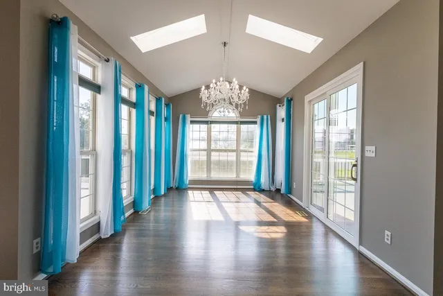 a spacious bedroom with a bed and a flat screen tv