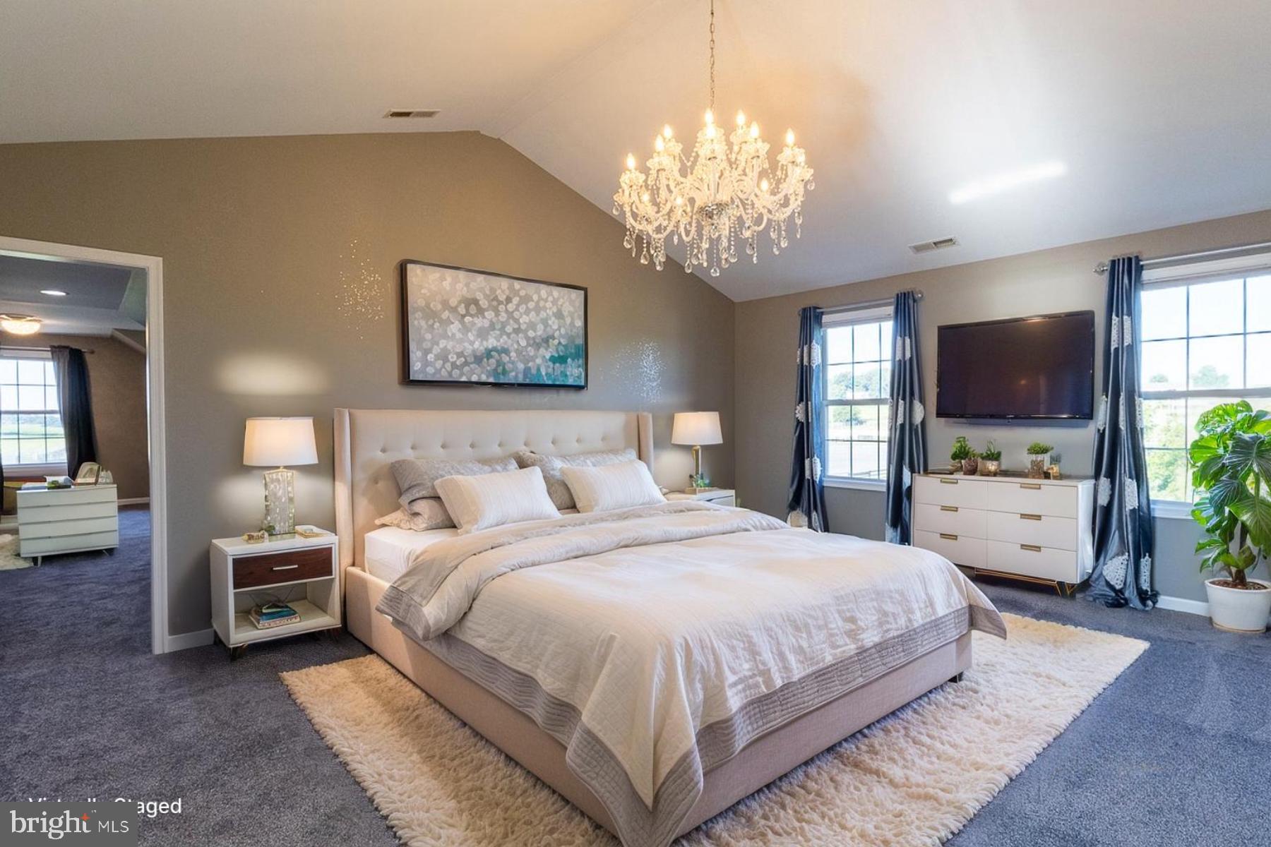 9630 Clemsonville Road Union Bridge, MD 21791 - Photo 6 of 70 a spacious bedroom with a bed and a flat screen tv