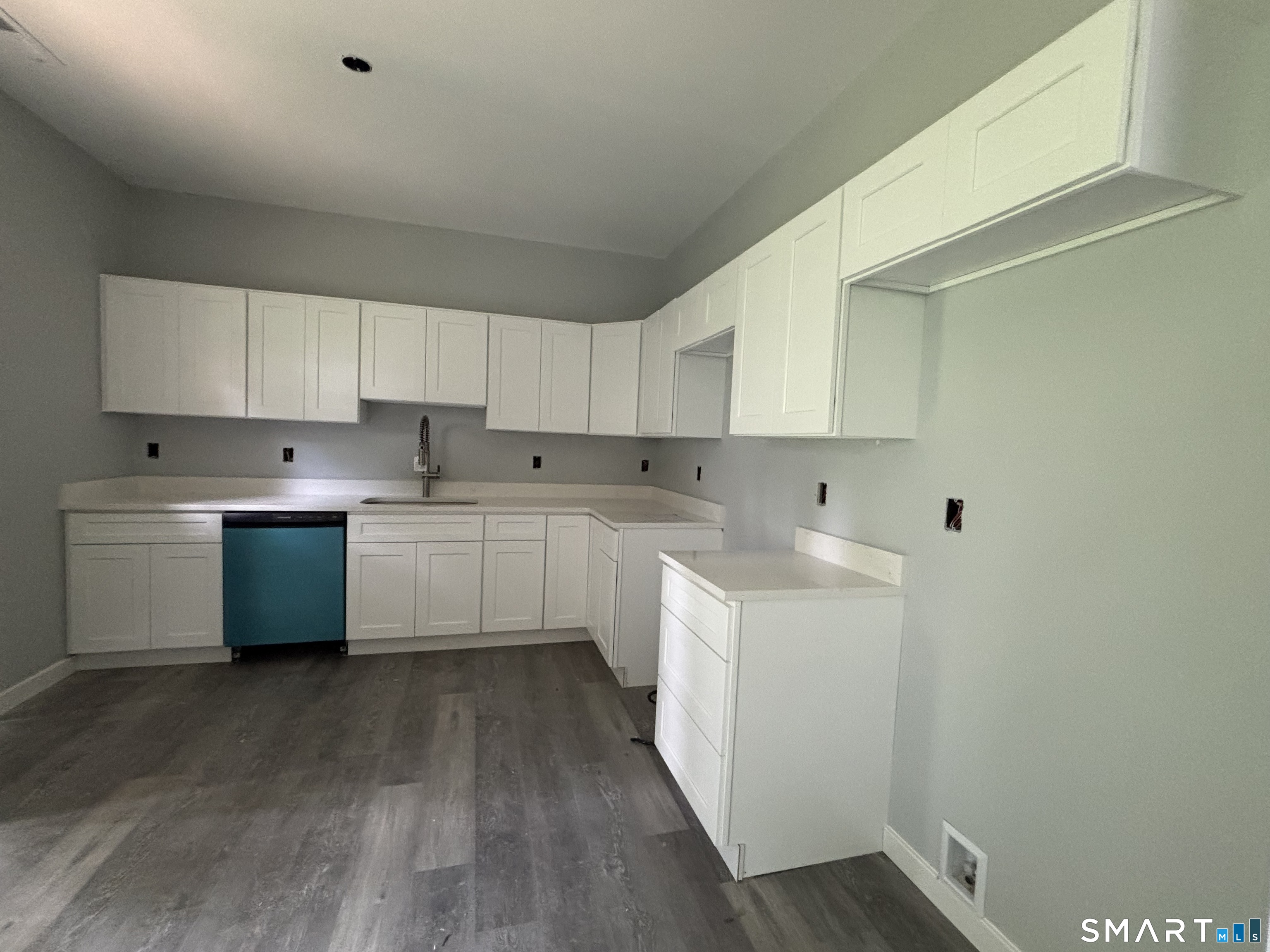 9 Putnam Park Road Bethel, CT 06801 - Photo 12 of 16 a kitchen with cabinets a sink and white stainless steel appliances