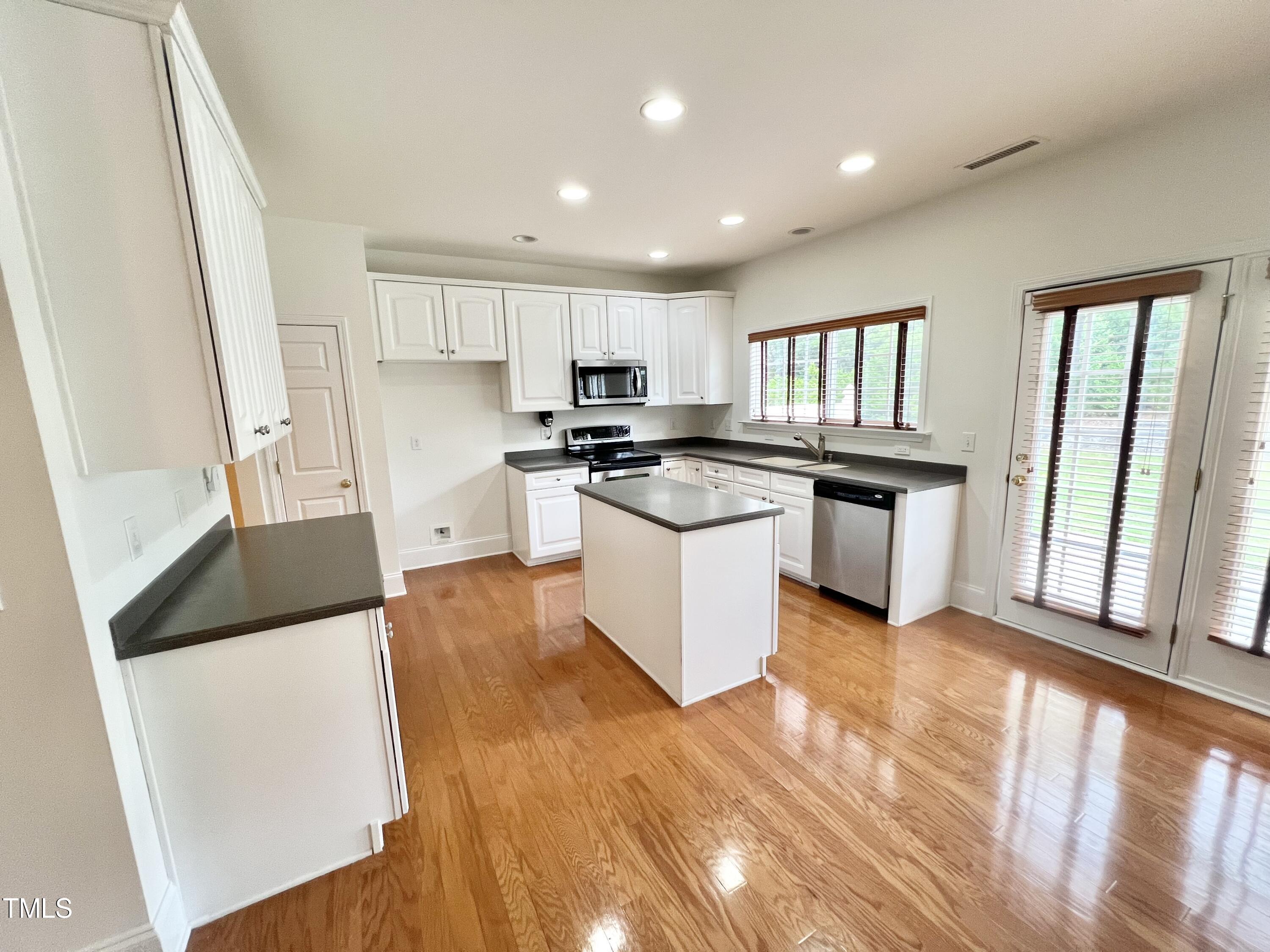 12221 Fox Valley Street Raleigh, NC 27614 - Photo 11 of 29 a kitchen with stainless steel appliances granite countertop a stove a sink and a refrigerator