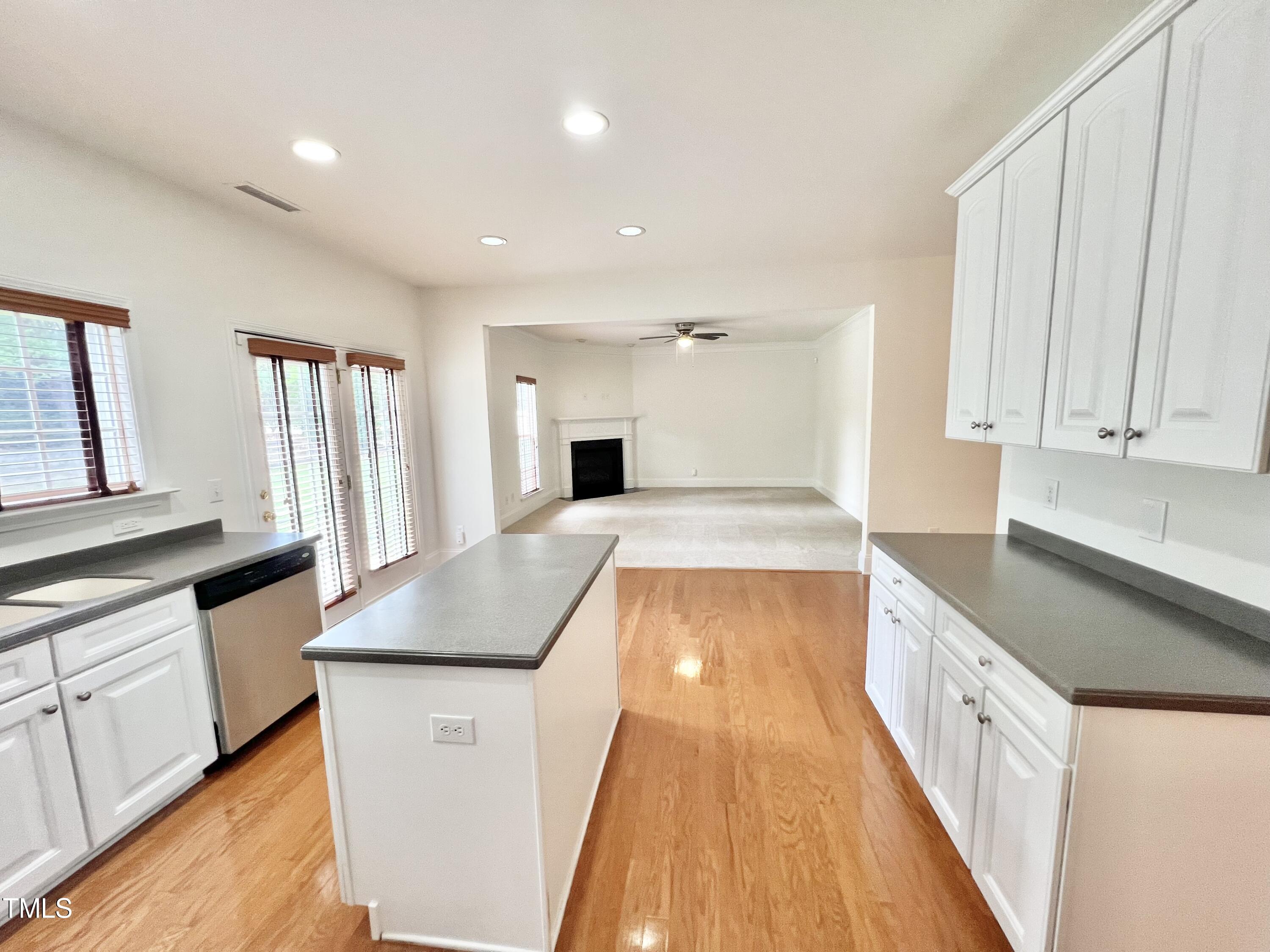 12221 Fox Valley Street Raleigh, NC 27614 - Photo 13 of 29 a large kitchen with granite countertop a sink and dishwasher a stove top oven with wooden floor