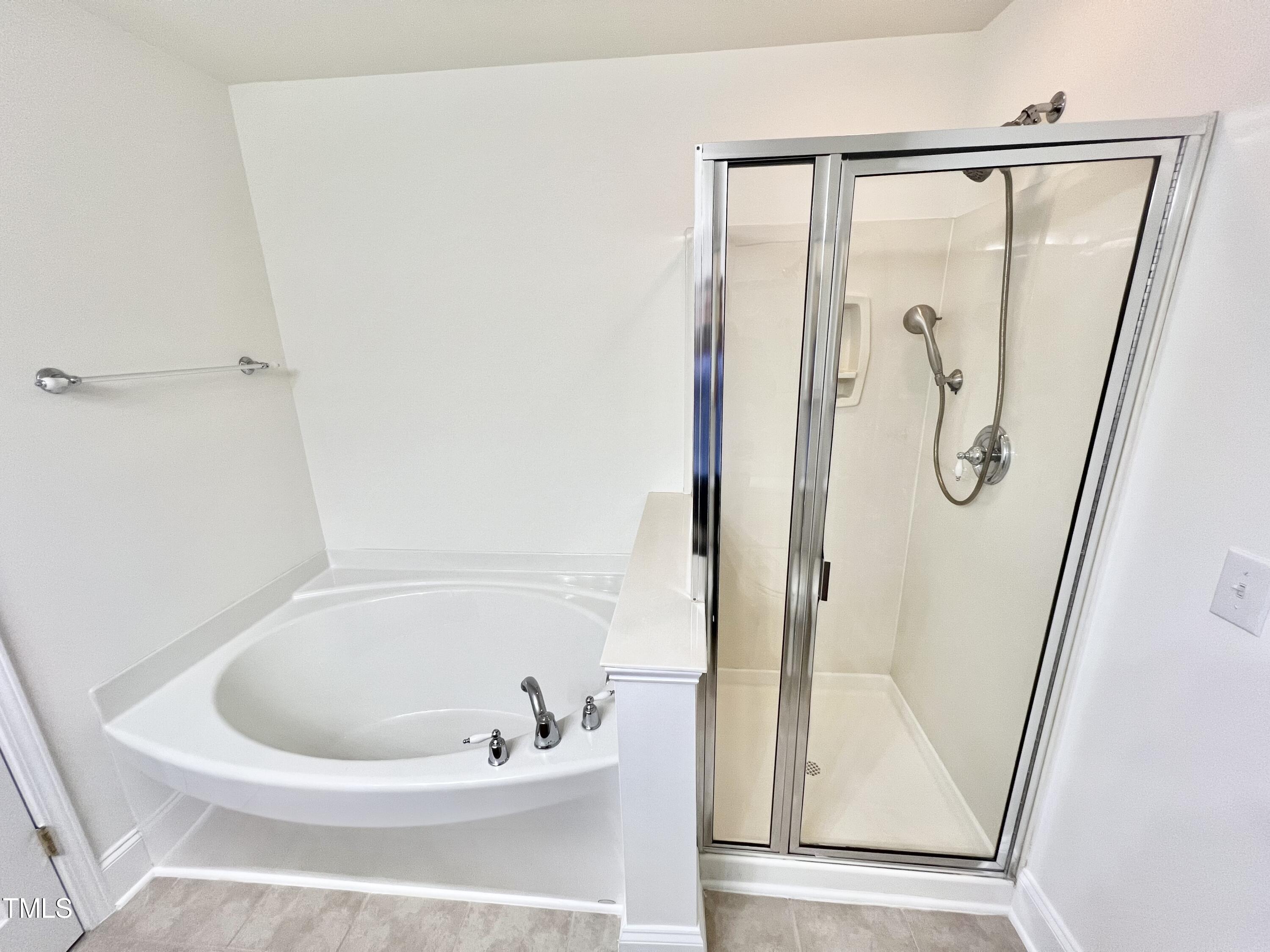 12221 Fox Valley Street Raleigh, NC 27614 - Photo 23 of 29 a bathroom with a bathtub and a shower